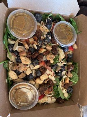 Spinach salad with blueberries and strawberries and homemade croutons