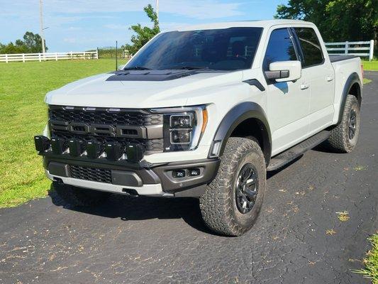 2023 Raptor V6 3.5 with a Livernois Motorsports Intercooler. Roush Cold Air Intake. (6) 6x6 Rigid Adaptive Lights. RPG leveling collars.