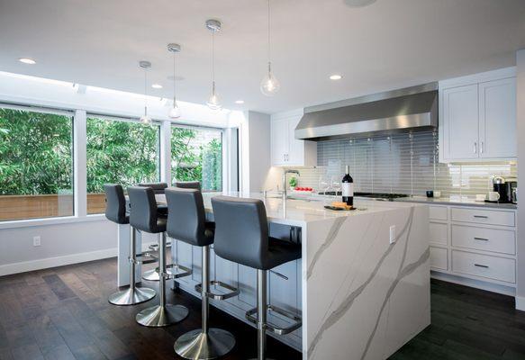 Function and style are key in the transformation of the kitchen to this large, open-concept modern space.