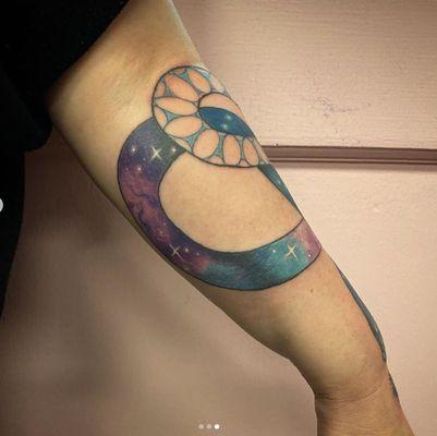 Cosmic snake on left forearm