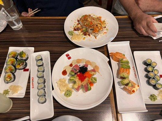 (From Left to Right) veggie roll, cucumber roll, (top) volcano roll, (bottom) Christmas roll, orange dragon roll, avocado roll