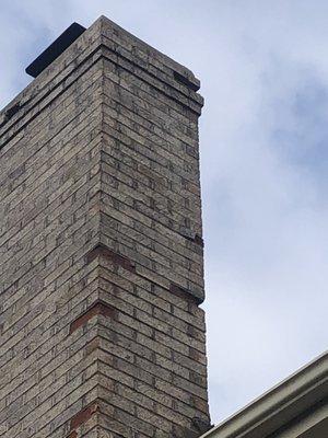 Water damage on brick chimney after it freeze and pop face of brick this is before