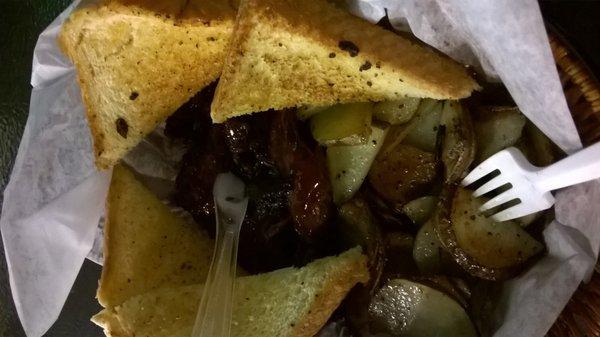 Brisket with Texas Toast and pan fried potatoes.  The brisket is sliced, not shredded!