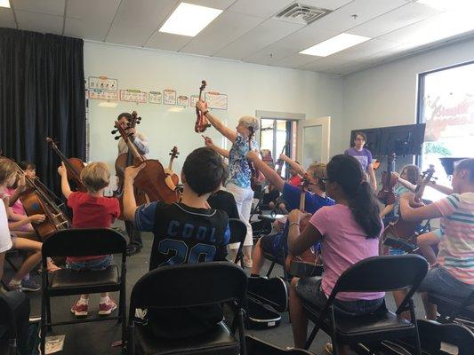 Learning about string instruments during one of our summer Exploring Instruments Camps