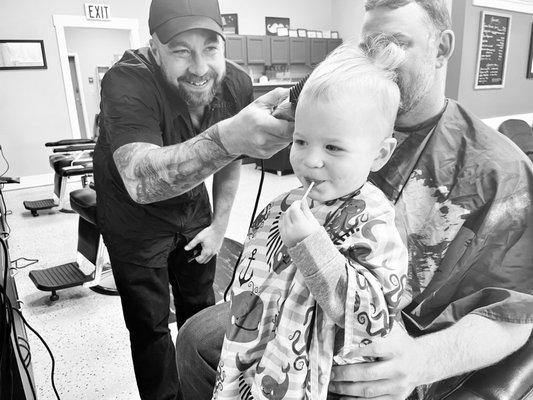 A little fella and his Dad; a Saturday morning tradition at the barbershop.  Walk-in's welcome daily