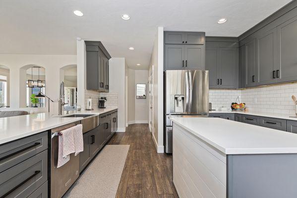 Elegant kitchen boasts ample lighting and a seamless blend of living space.