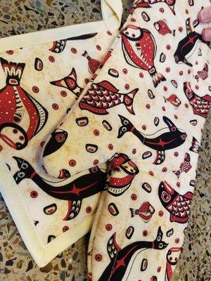 Oven mitts with orca whale and salmon themes handcrafted by local Indigenous artist, Faith P.