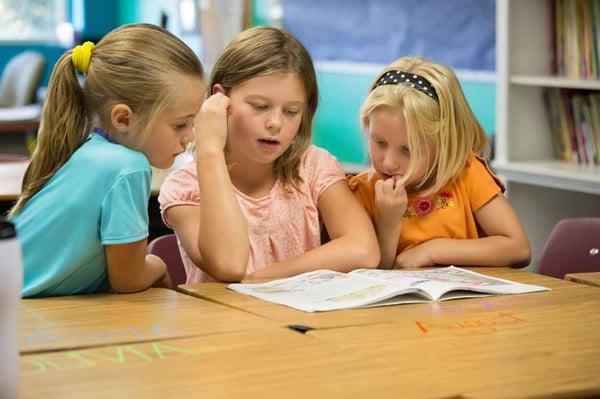 Older students are paired with younger students for reading during Book Partners every week.