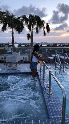 Standing in the jacuzzi on the rooftop.