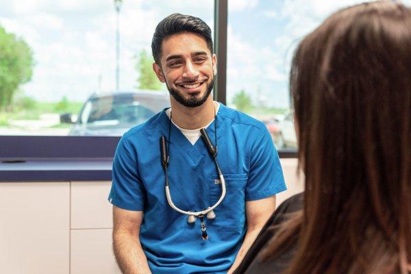 Dr. Siddiqui speaking with a patient about their treatment at Advanced Family Dental of Midlothian