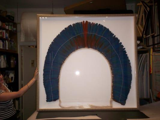 Framing of South American feather headdress.