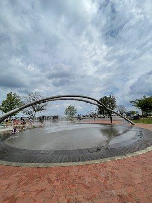 Splash pad with climbing ropes in back right corner