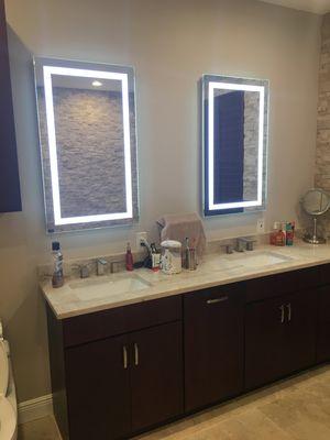 New double vanity with lighted Led mirrors over vanity.