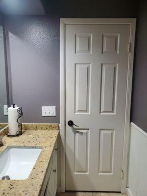 Bathroom baseboards, walls, and cabinet