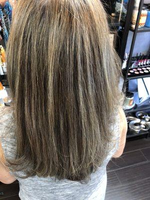 This client is doing a reverse weave to let her gray hair grow out. We put gray highlights in her hair.