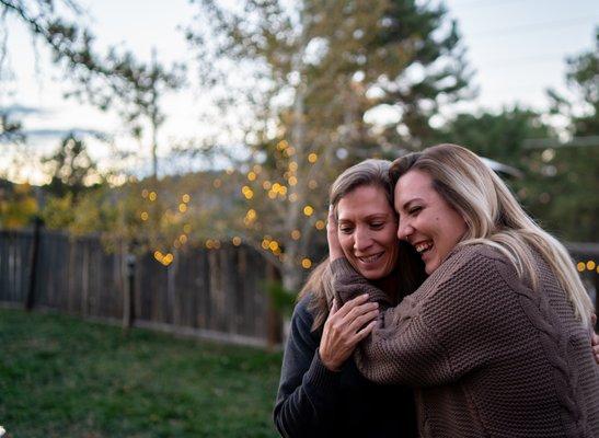 Mother of the bride embraced by her daughter on her wedding day.