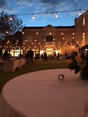 Nighttime events in the rose garden are illuminated by string lights, giving this special outdoor gathering space a warm and cheery glow.