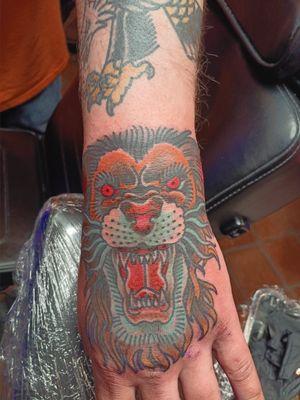 Here's a lion's head on wrist and hand done by John Gilmore.