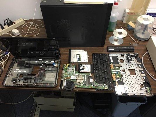 A laptop has been disassembled in order to replace the processor fan.