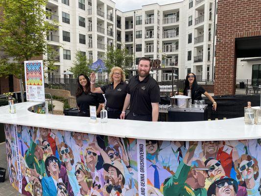 Several Liquid Catering bartenders behind the bar at Artisphere in Downtown Greenville