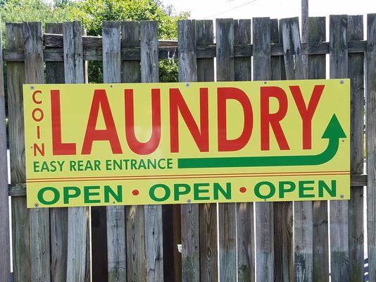 Close-up of directional sign for easy rear door entrance