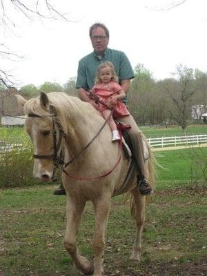 Tim riding his horse Duke with his grand daughter