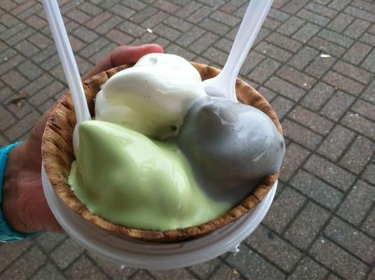 Triple soft ice cream in a waffle cone. Vanilla, green tea and black sesame