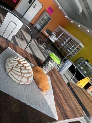 bread, coffee and kolaches and in the back there's a variety of bread and their food stand