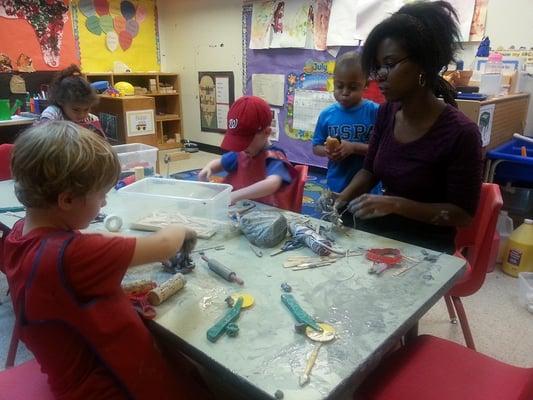 Pre- K students explore clay with their teacher, Ms. Amanda.