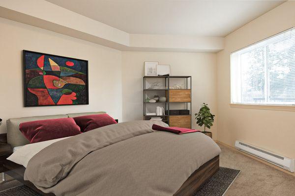 Spacious bedroom with taupe carpets and a large window on the right wall.