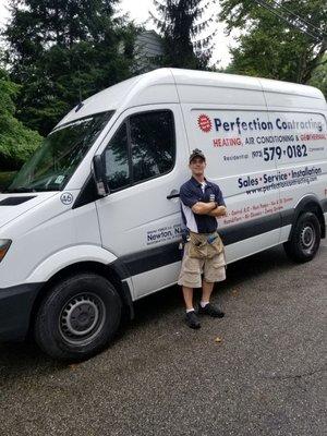 A Perfection Contracting employee standing in front of our service truck.