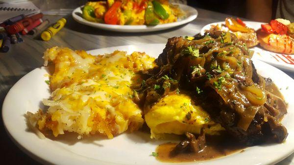 Steak omelette with a side of cheesy hash browns.