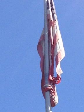 This torn, disgraced American flag is on the pole outside Collier's International, 1301 E. Orangewood in Anaheim CA.