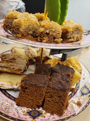 Baklava, sliced apple fritter bread and gingerbread squares.