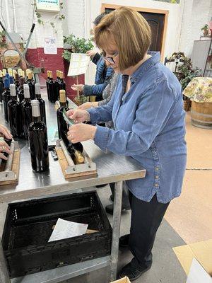 In this photo, my wife is labeling her wine.