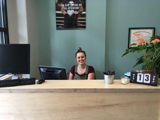 Ashley taking care of business at the reception desk