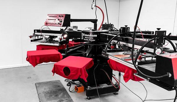 Newstate Branding Co. in house 6 Color automatic screen printing press