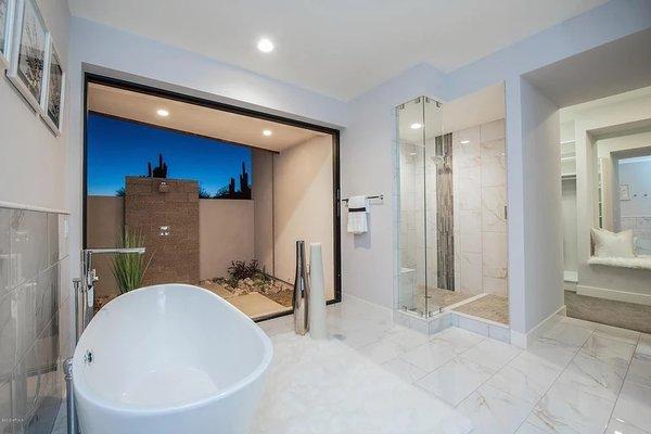 Novabuilt Homes is setting the New Standard with this indoor/outdoor access modern bathroom with outdoor shower and pocket door!