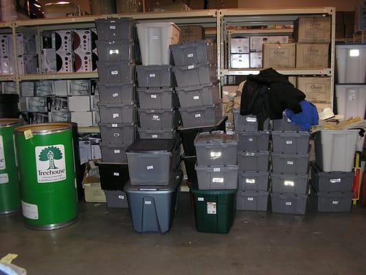 Massive piles of donated clothing now neatly tagged, sorted, and boxed for Treehouse Wearhouse.