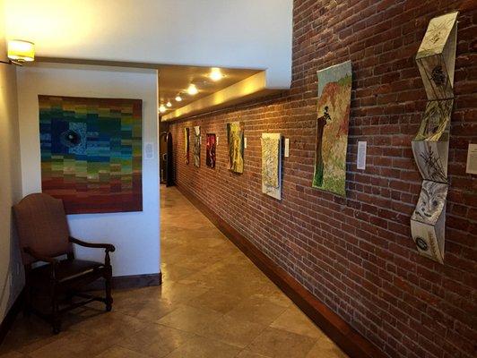 We feature the work of local artists in our hallway.