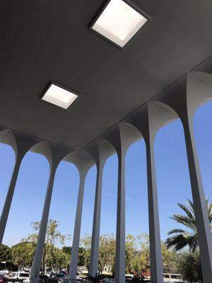 Left corner looking up and out of the entrance of the building. You can see the arches made by the shape of the long lines up to the roof.