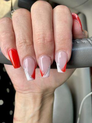 Coffin shaped, red and white French tips with a touch of glitter