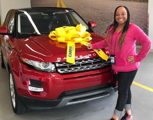 A Sierra member shows off her new car, proudly financed with the credit union