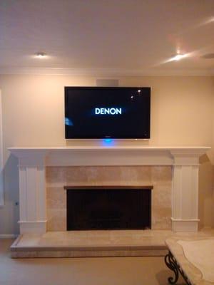 Flat screen above a fireplace.