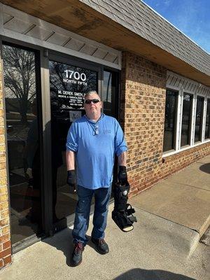 My husband leaving Dr Smith's office wearing TWO shoes after wearing only one for four months!