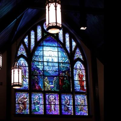 The middle part of this window is by Tiffany. When you walk in the church down the aisle, look up and back.