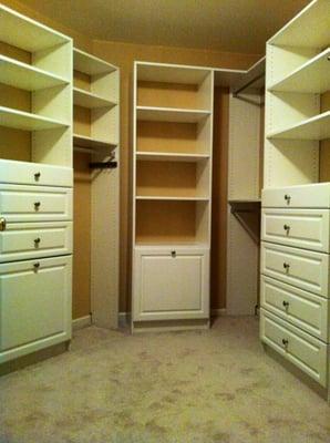 Walk-in closet in white. Two tilt-out hampers, drawers, adjustable shelving and hanging space.