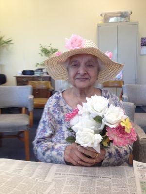 A participant enjoys the bouquet she made.