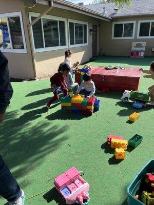 Students learning how to work together to build a house.