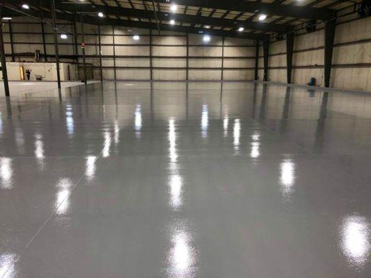 Epoxy floor with an ultra-hard, never strip, low maintenance top coating